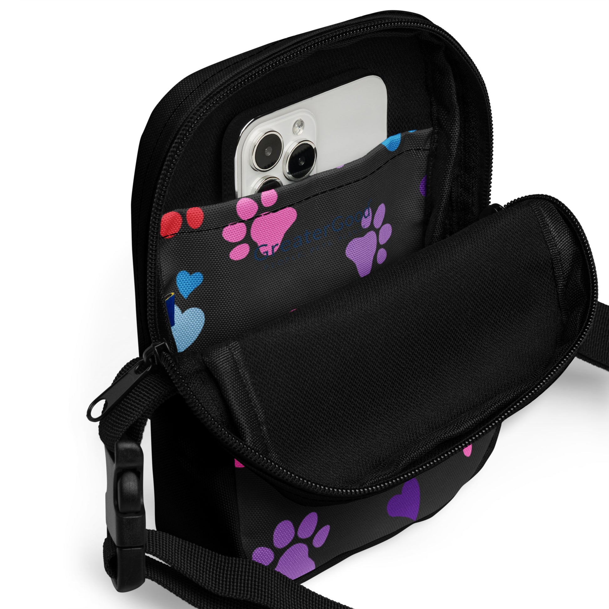 Close up of the inside pocket of a Black crossbody bag with colorful paw prints on a white background