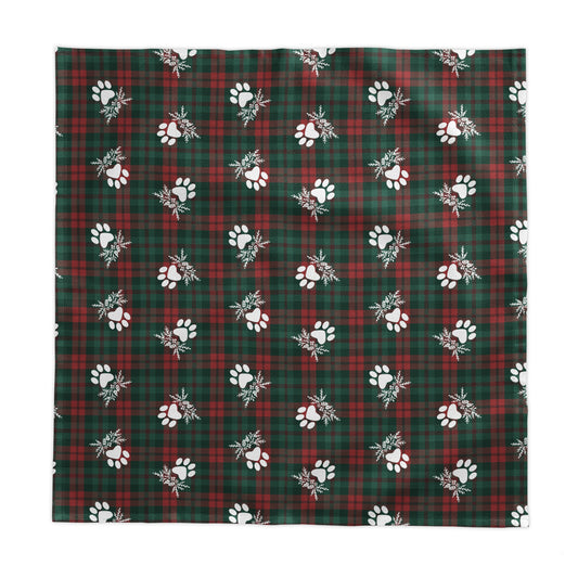 a green and red plaid tablecloth with white paw prints on a white background