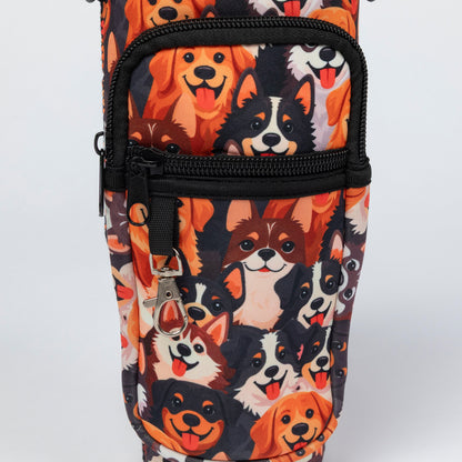 A close-up of a fabric bag or pouch featuring a repeating print of various dog faces in orange, black, white, and brown, with black zippers and a silver keychain clip.