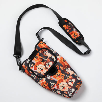 A small crossbody bag with a black adjustable strap, featuring a dense cartoon dog print in orange, black, cream, and white on a clean white background.