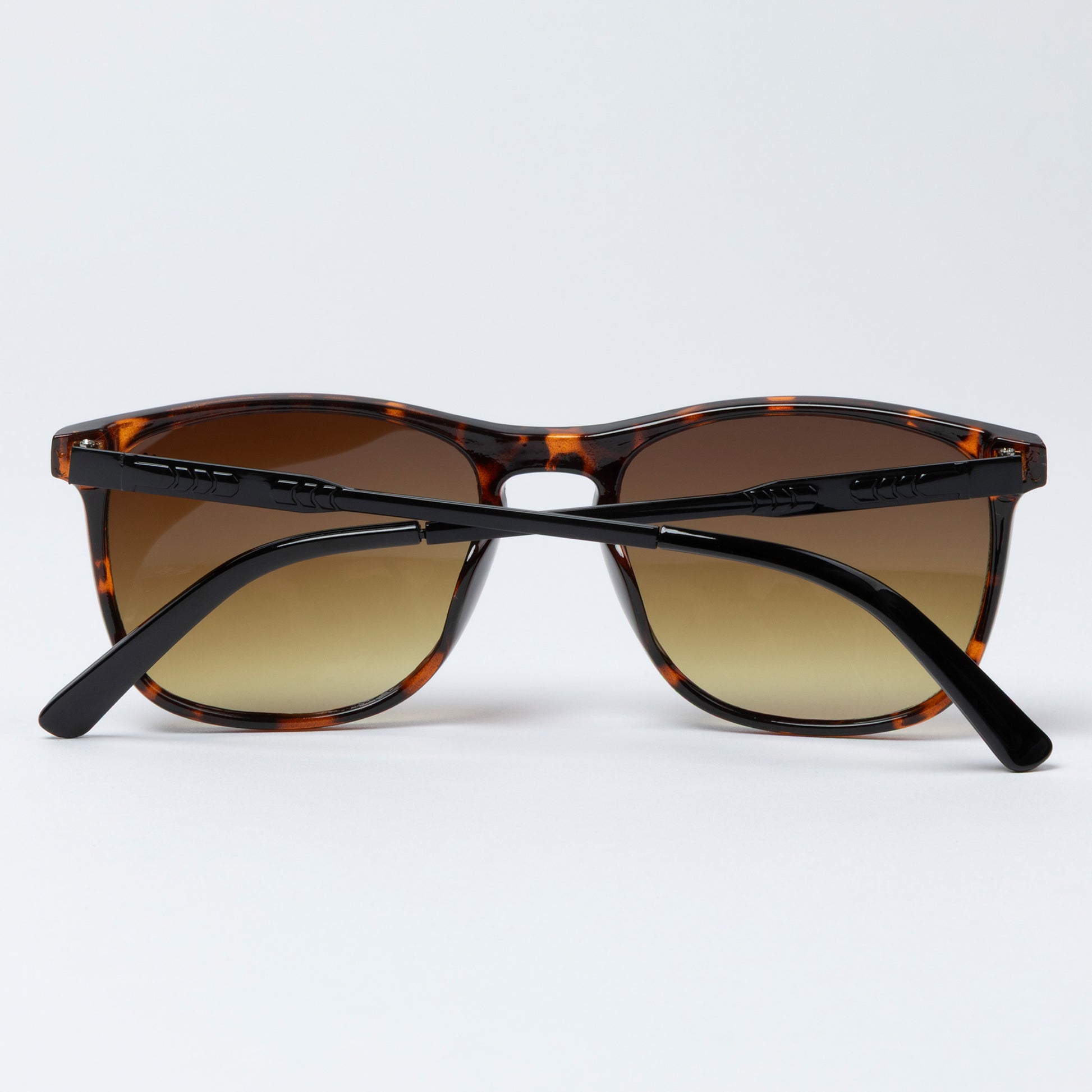 Sunglasses with tortoiseshell frame and brown lenses on a white background