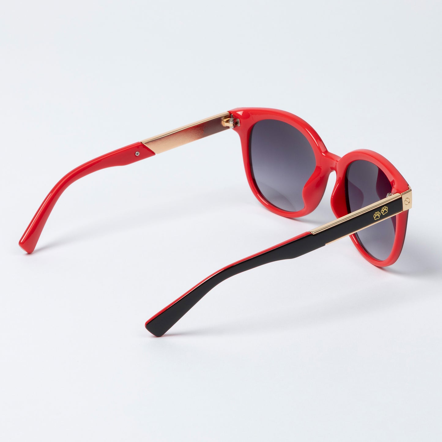 Sunglasses with red and black frames on a white background