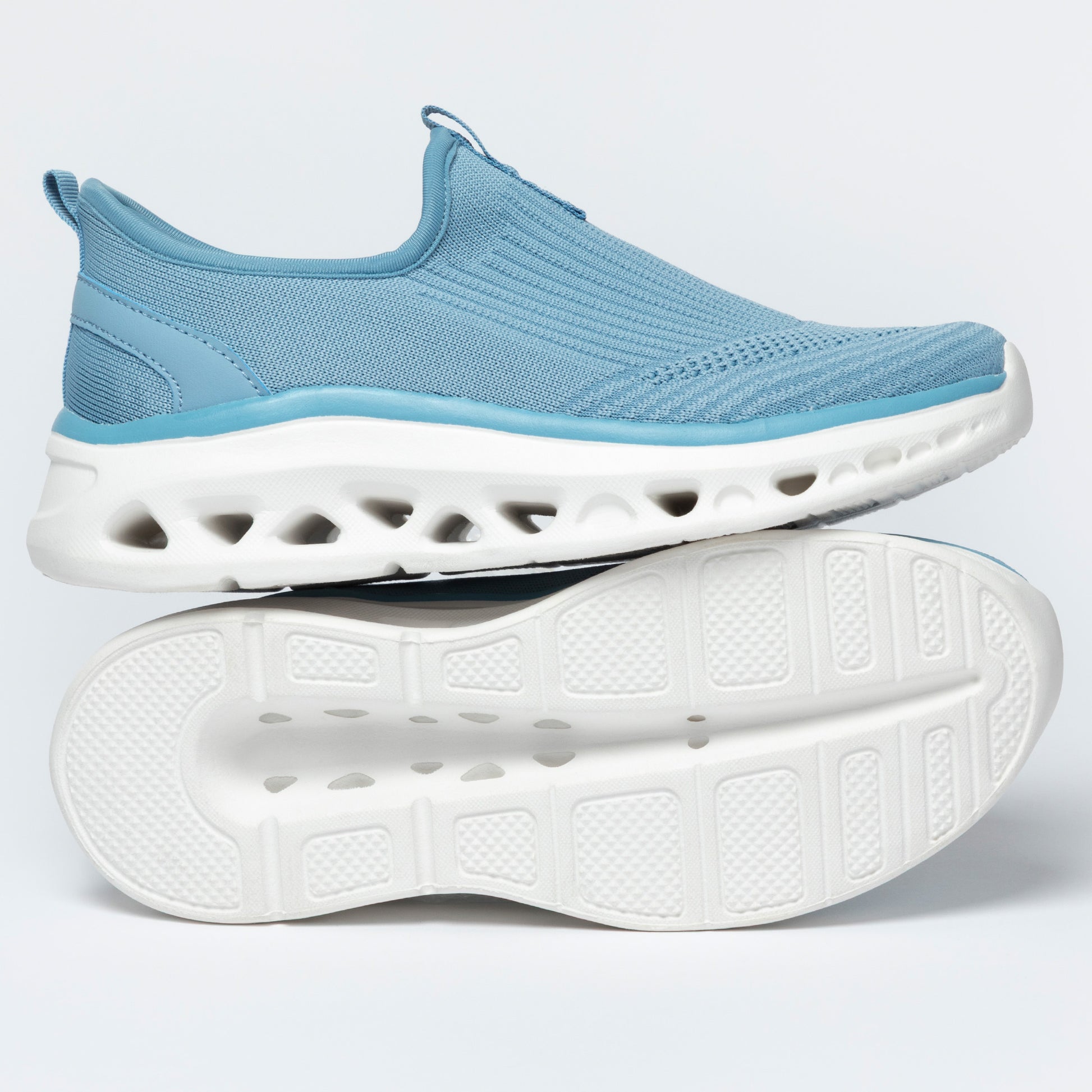 Light blue slip-on shoes with white soles on a light gray background