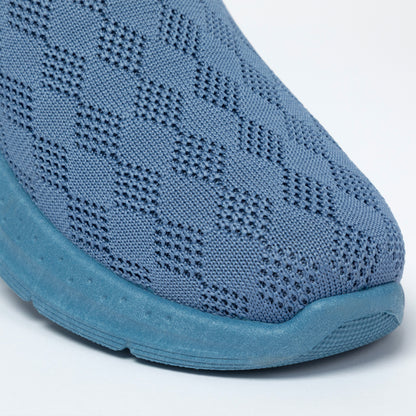 Blue slip-on shoe with knitted upper on a white background