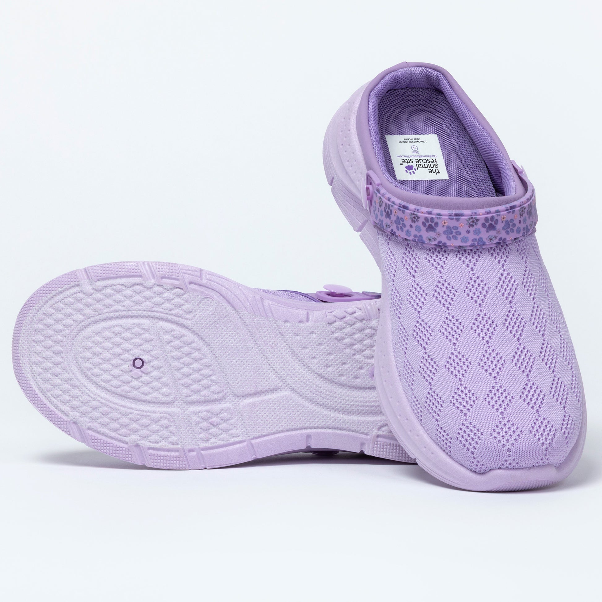 Pair of purple clog shoes on a white background