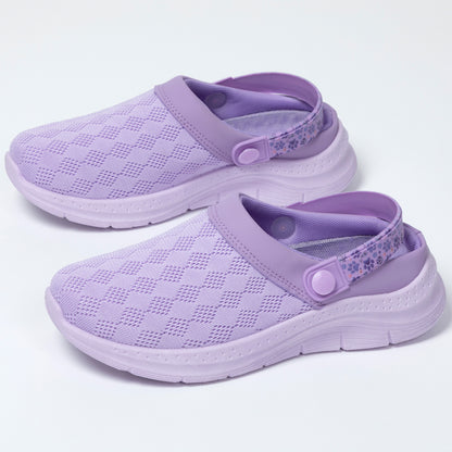Pair of purple clogs on a white background