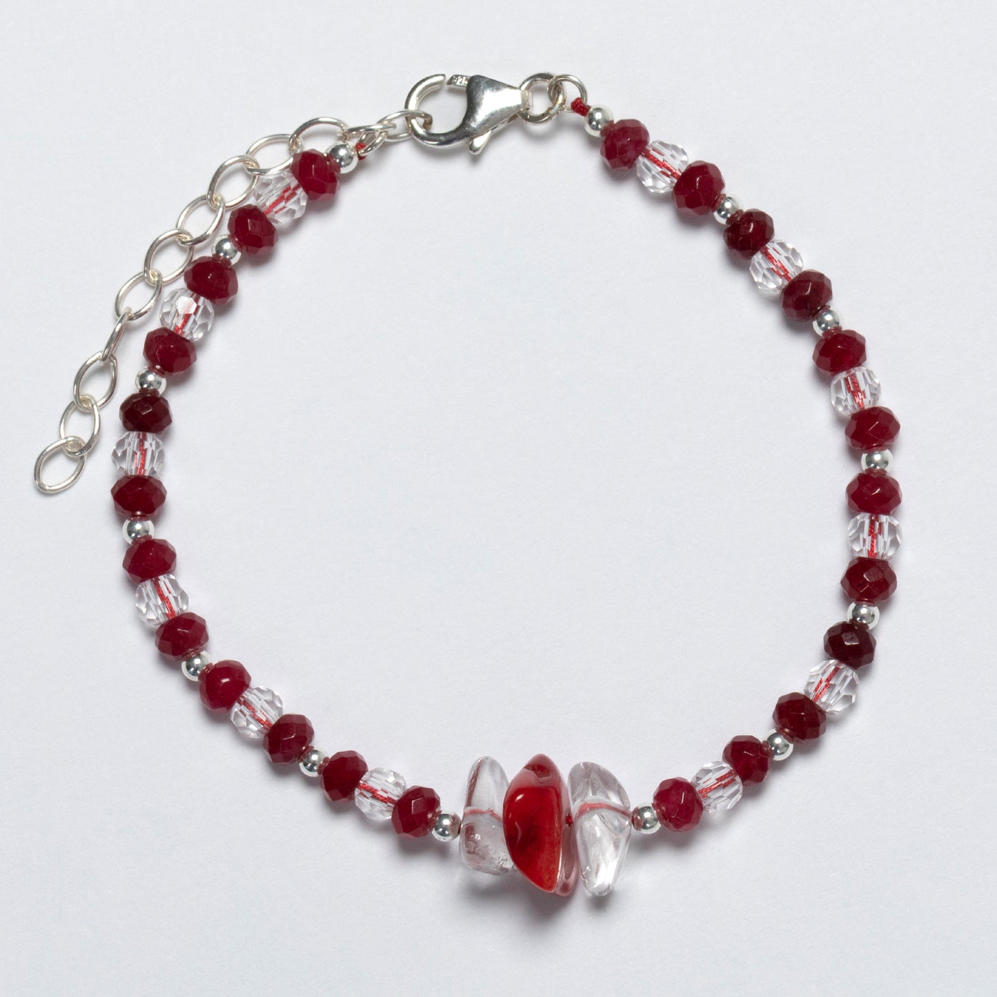 Bracelet with red and clear beads on a white background