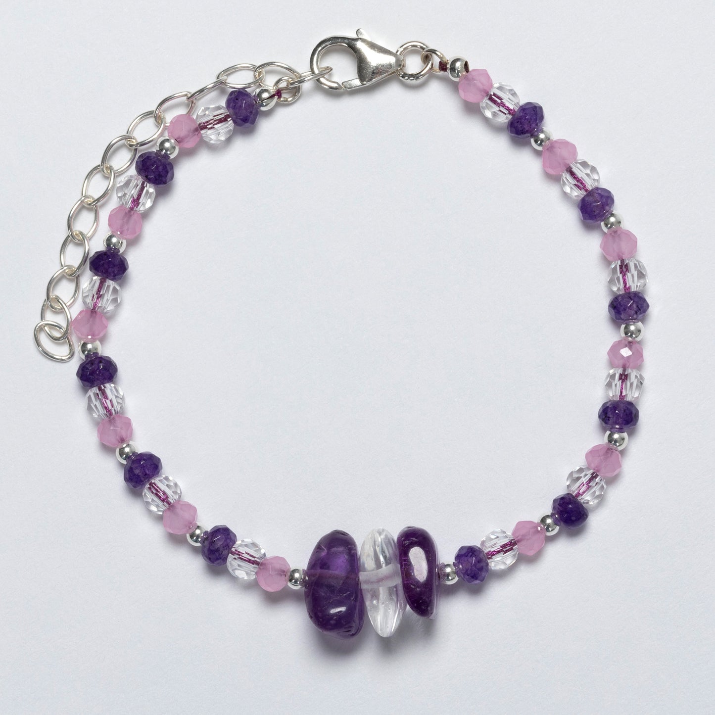 Beaded bracelet with purple and pink beads on a white background
