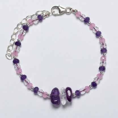 Beaded bracelet with purple and pink beads on a white background