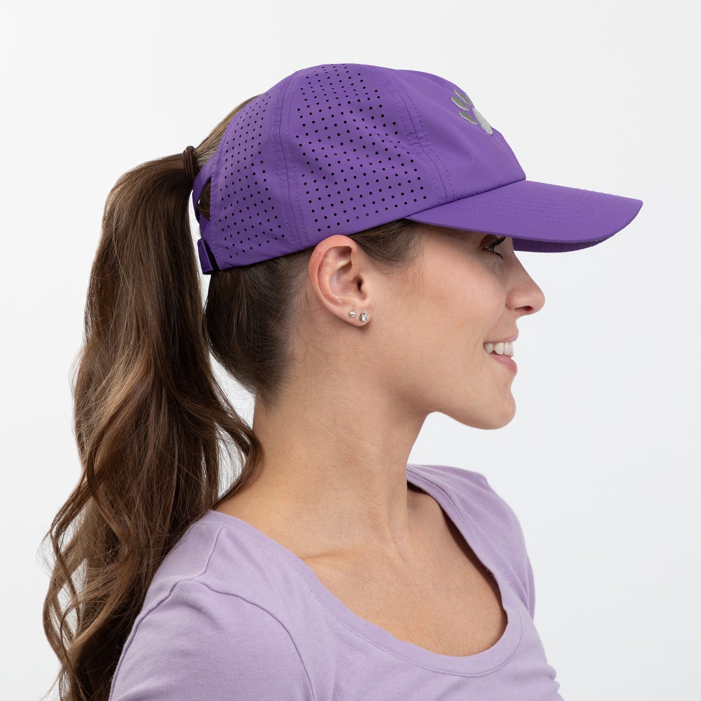 Woman wearing a purple cap and shirt on a white background