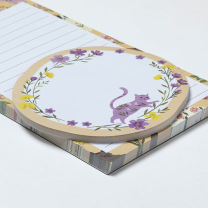 Notepad with a purple cat illustration on a floral border