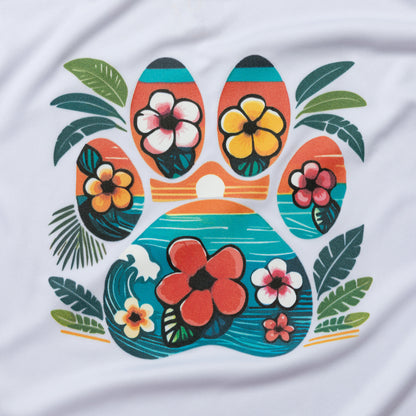 A close-up of a white fabric surface featuring a colorful tropical paw print graphic with hibiscus flowers and palm leaves.