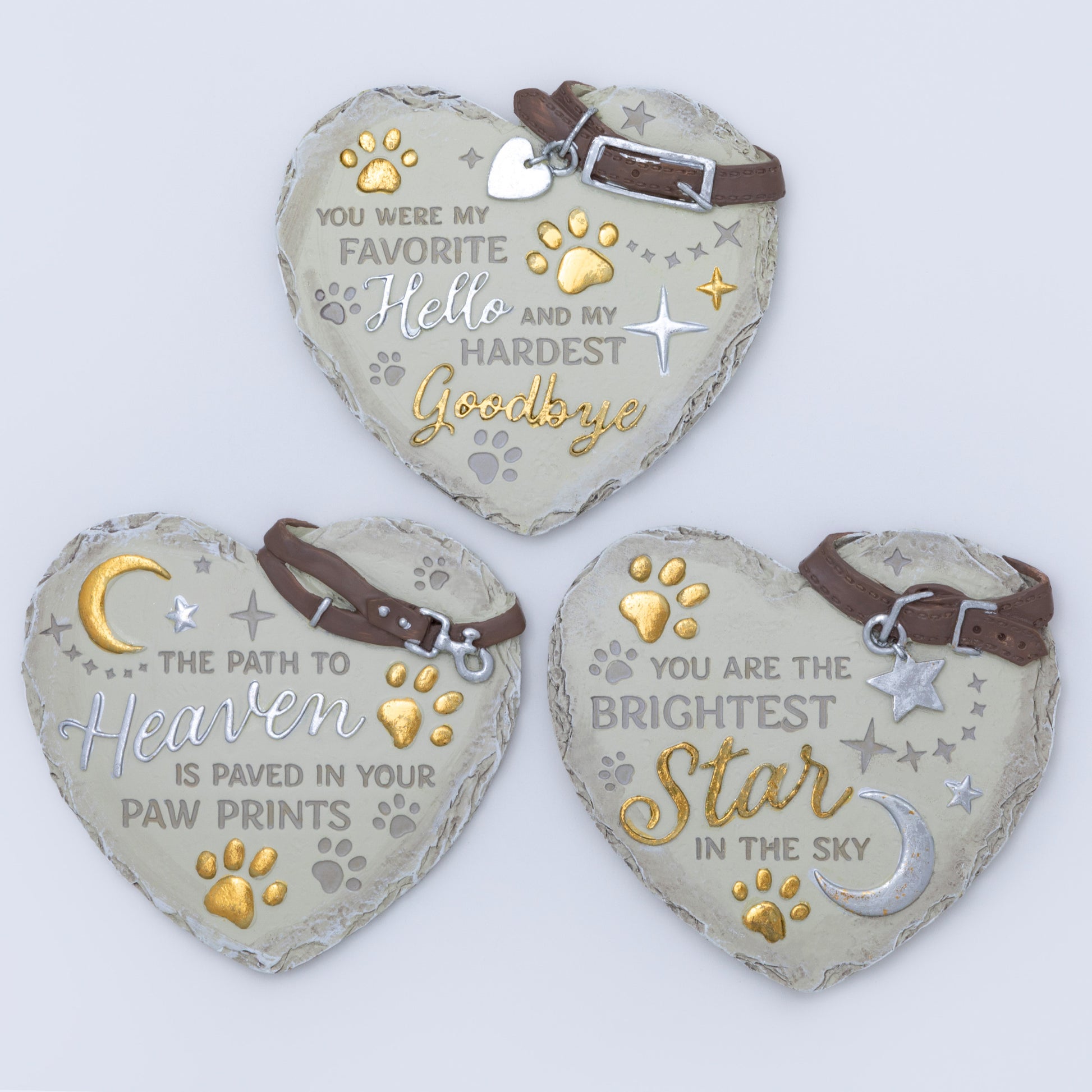 Three heart-shaped pet memorials with engraved messages on a light background
