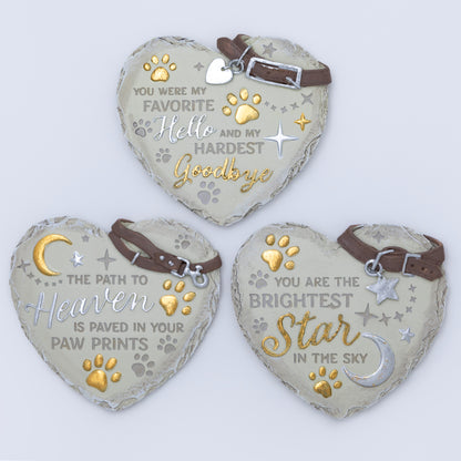 Three heart-shaped pet memorials with engraved messages on a light background