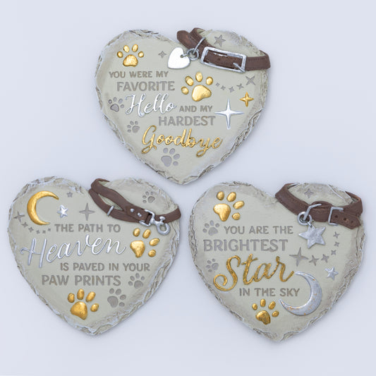 Three heart-shaped pet memorials with engraved messages on a light background