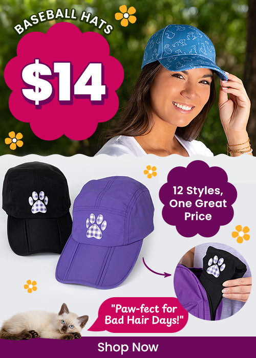 Shop $14 baseball hats available in 12 styles, featuring colorful paw print designs in black and purple. Proceeds help support shelter pets and more through The Animal Rescue Site and GreaterGood.