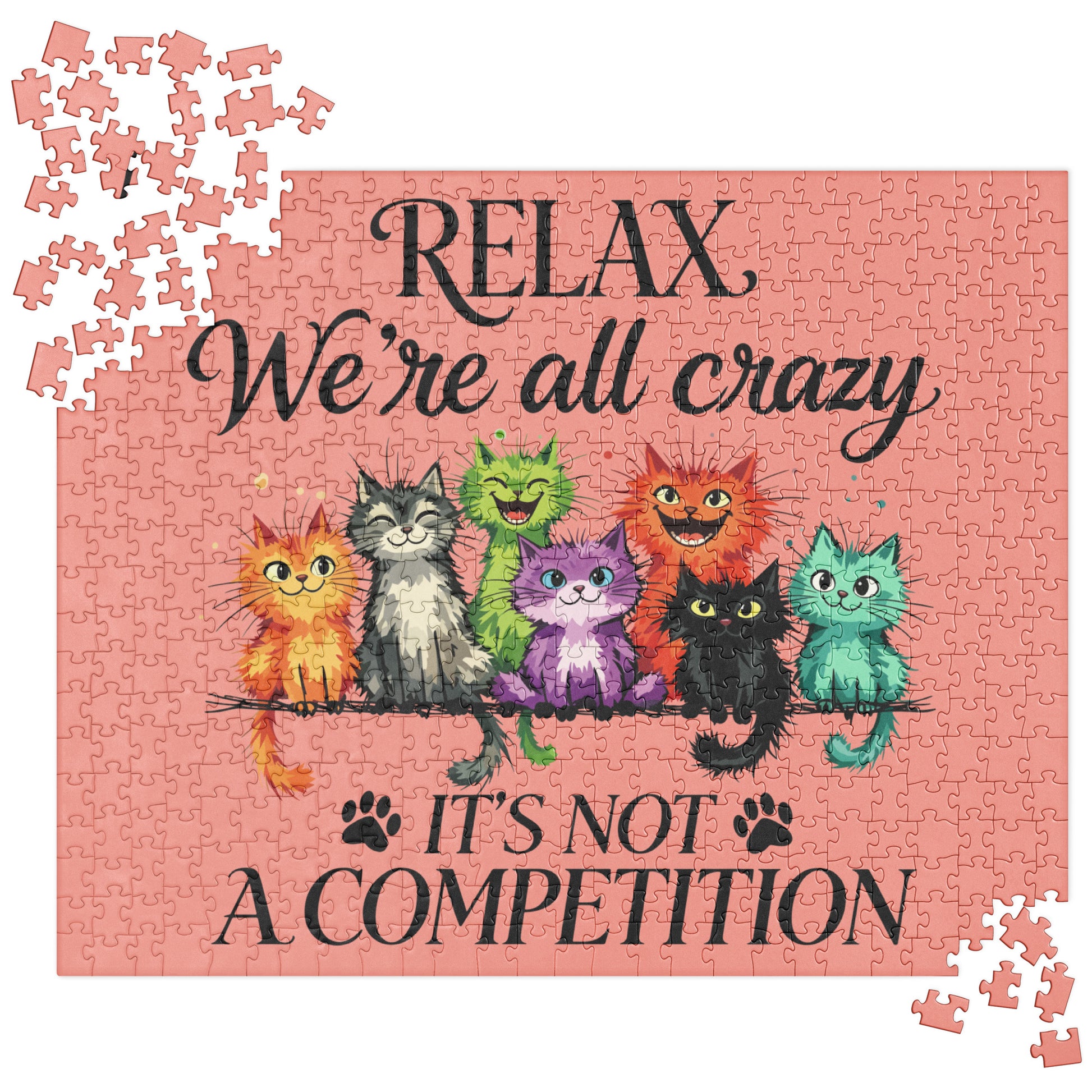 A completed jigsaw puzzle featuring a pink background with the text 'RELAX We're all crazy' and 'IT'S NOT A COMPETITION' in black script. Colorful cartoon cats sit on a branch across the center, and a few loose puzzle pieces are scattered around the corners.