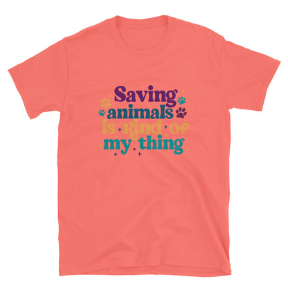 coral shirt that reads Saving Animals is kind of my Thing with several paw print and sparkle images in a purple, yellow and blue font.
