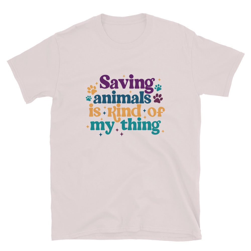 ice gray  shirt that reads Saving Animals is kind of my Thing with several paw print and sparkle images in a purple, yellow and blue font.