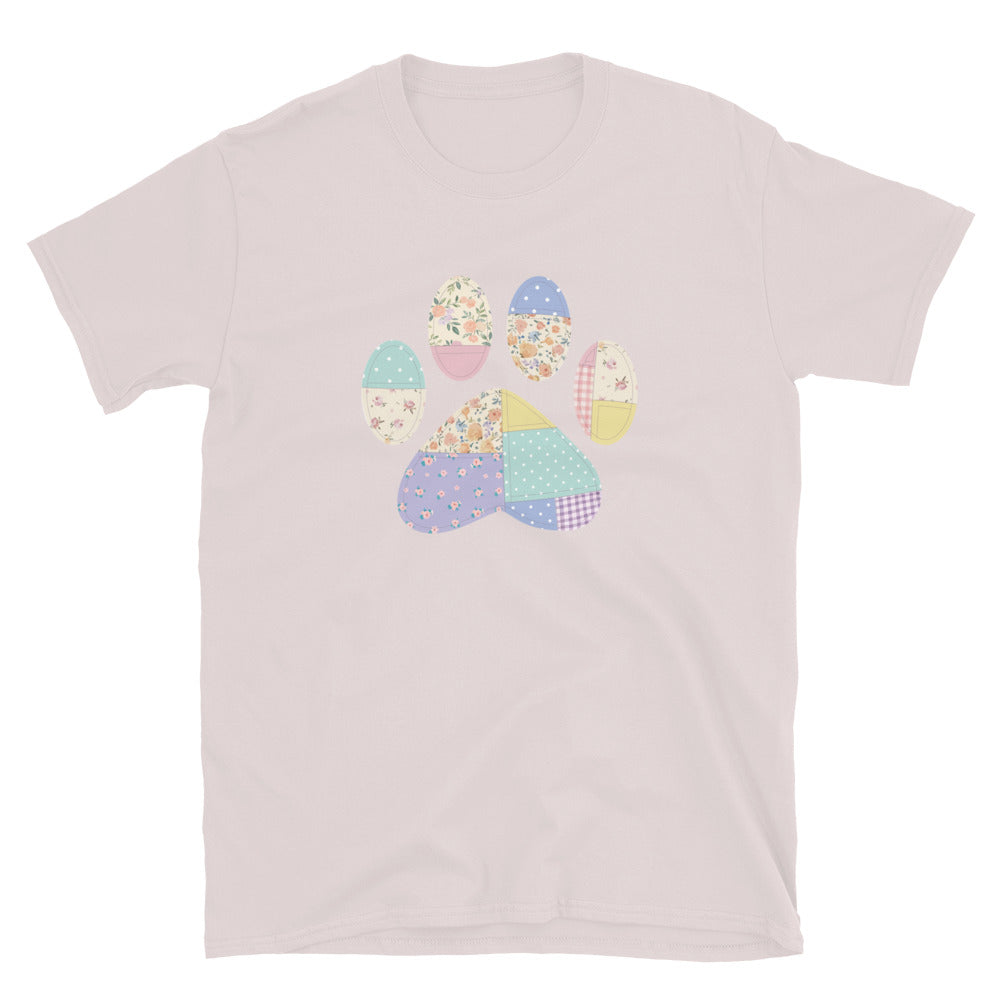 Light pink t-shirt with a colorful paw print design on a white background