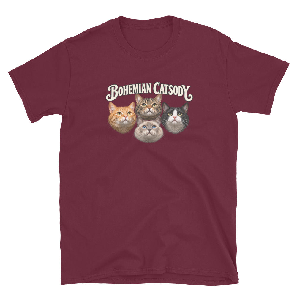 A maroon short-sleeve crewneck t-shirt featuring a graphic of four different cat faces with the text 'BOHEMIAN CATSODY' printed above them, displayed on a clean white background.