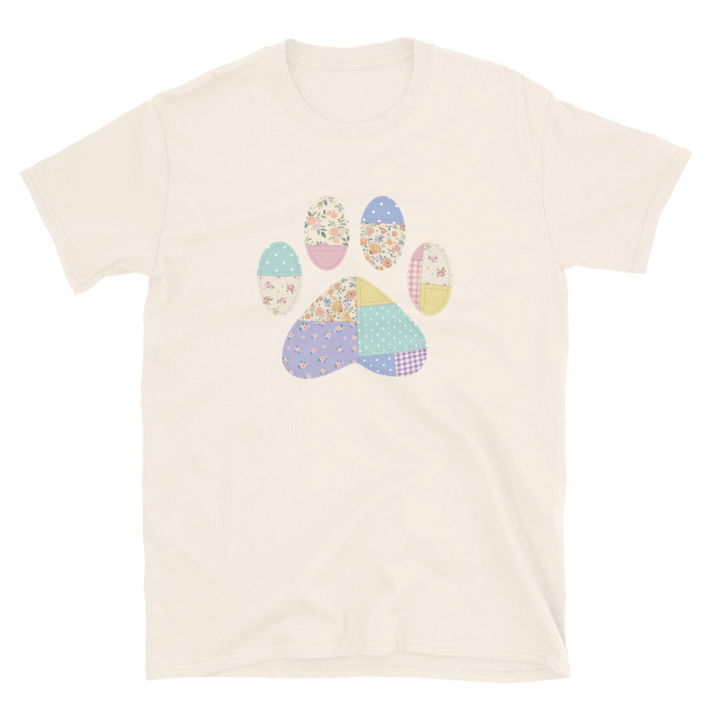 Beige t-shirt with a colorful paw print design on a white background