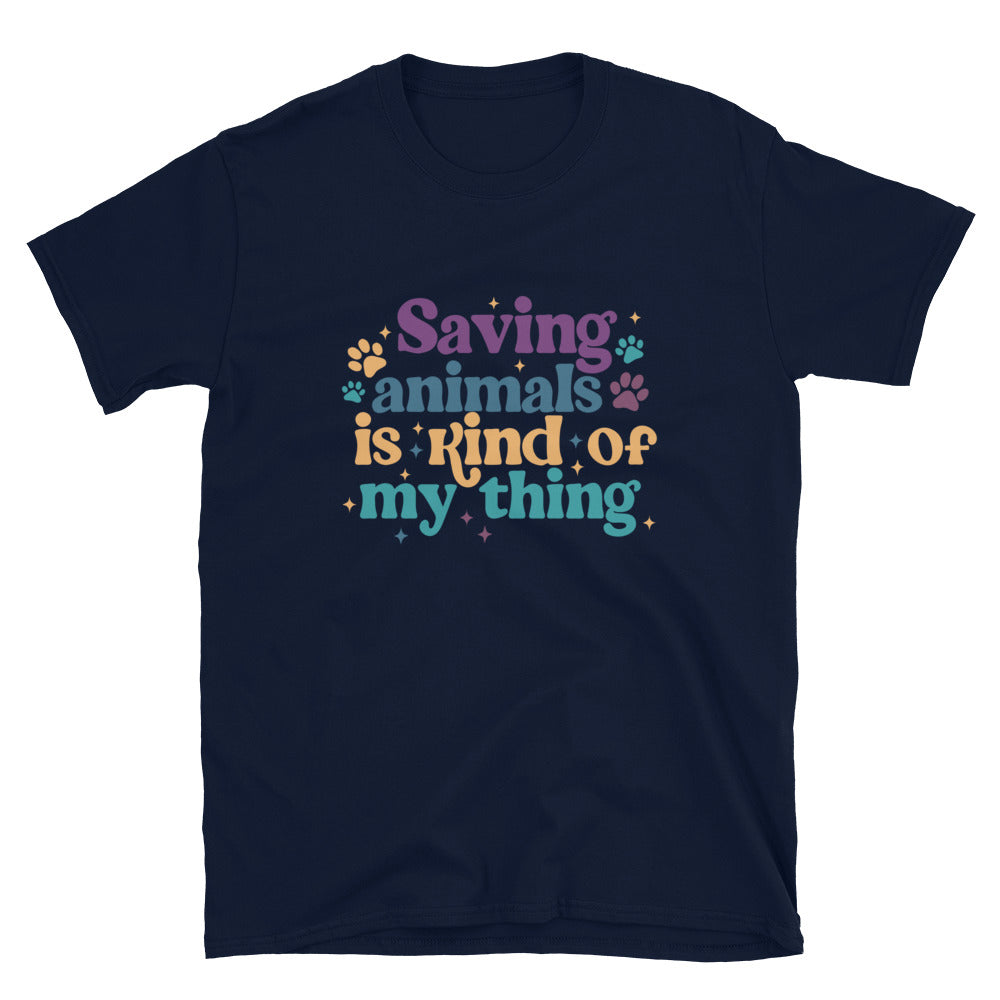 Navy shirt that reads Saving Animals is kind of my Thing with several paw print and sparkle images in a purple, yellow and blue font.