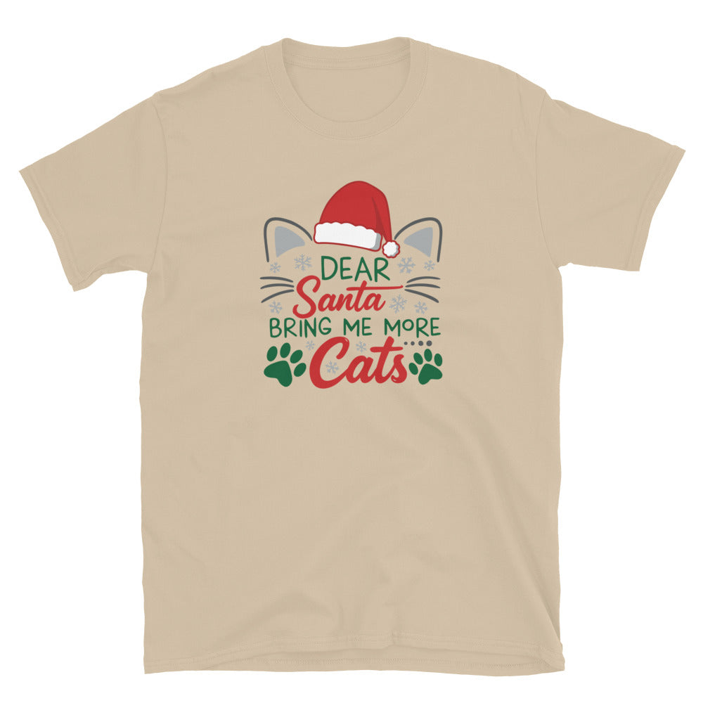 tan Short Sleeve Shirt that reads Dear Santa Bring Me More Cats. Featuring a santa hat, cat ears and cat whiskers with paw prints