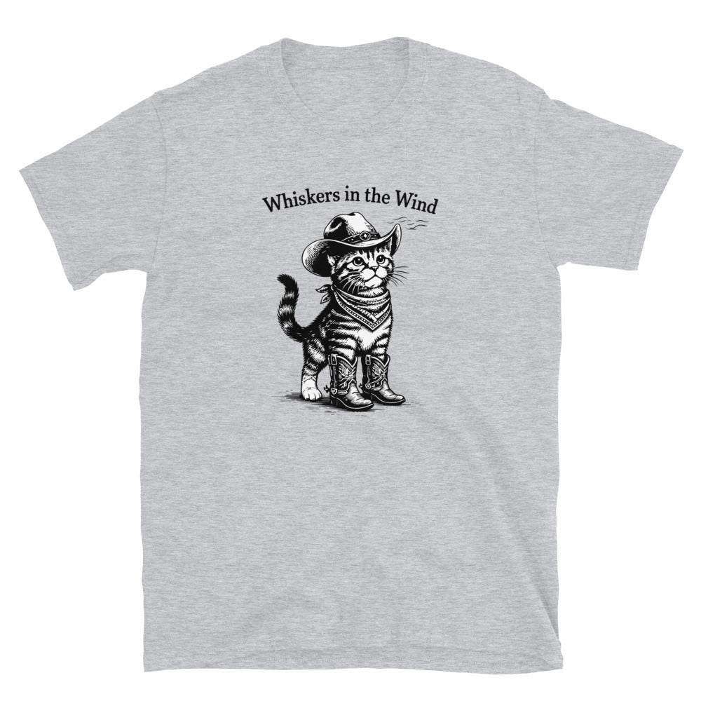 Gray t-shirt with a graphic of a cat in cowboy attire and text 'Whiskers in the Wind' on a white background.