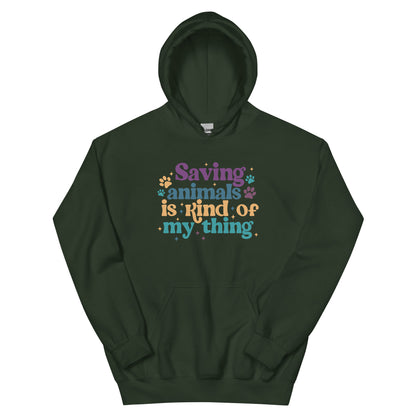 Dark Green Hooded Sweatshirt that reads Saving Animals is kind of my Thing with several paw print and sparkle images in a purple, yellow and blue font.