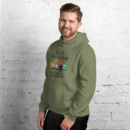 Man wearing a green hoodie standing against a white brick wall