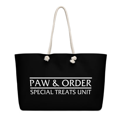 Black tote bag with tan rope handles. Design is black with white lettering that reads: Paw & Order- Special Treats Unit