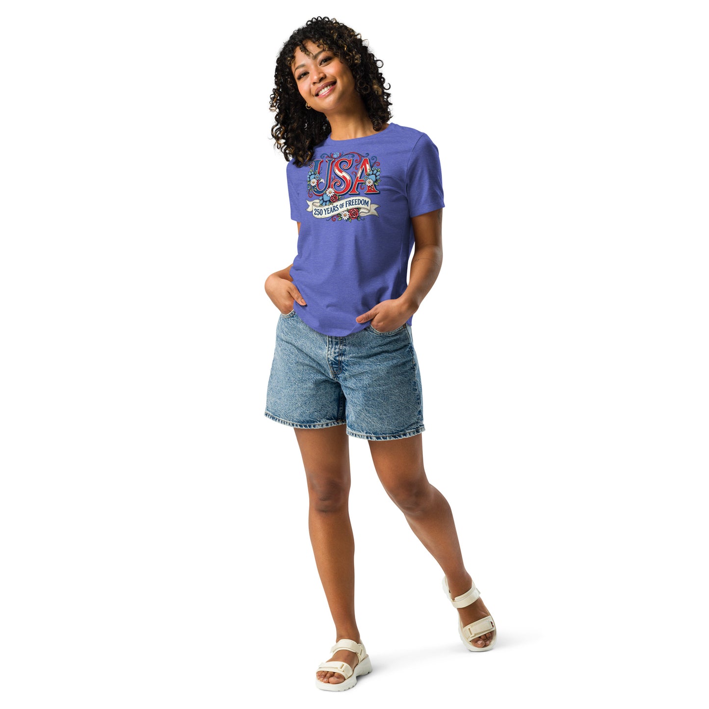 Woman wearing a purple t-shirt with colorful graphics and denim shorts on a white background