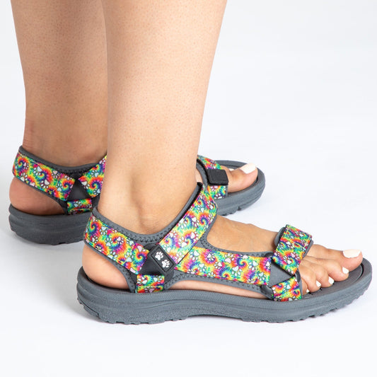 Colorful sandals with adjustable straps, showcasing a vibrant pattern and comfortable sole.