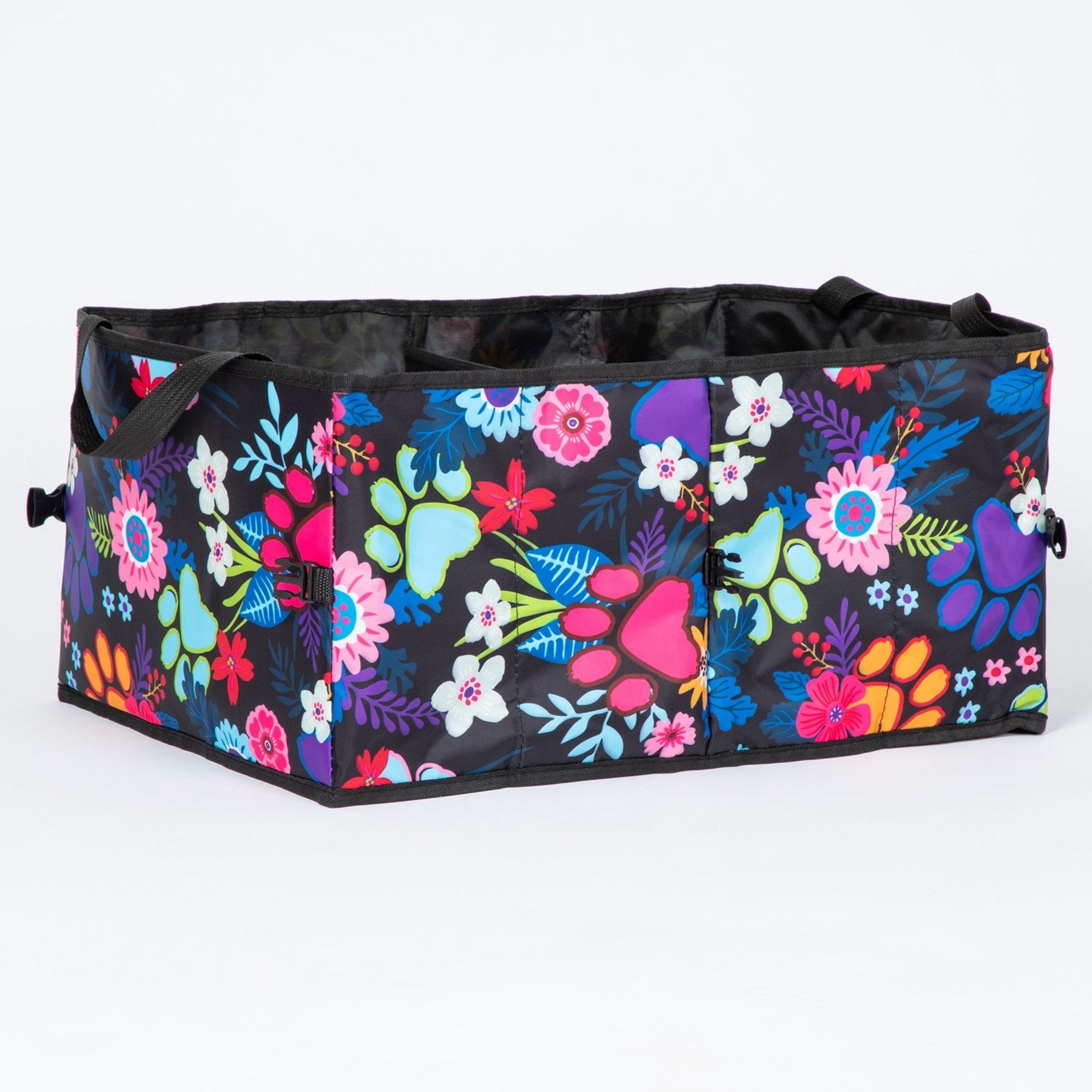 A collapsible car trunk organizer with a bright floral and paw print design on a white background.