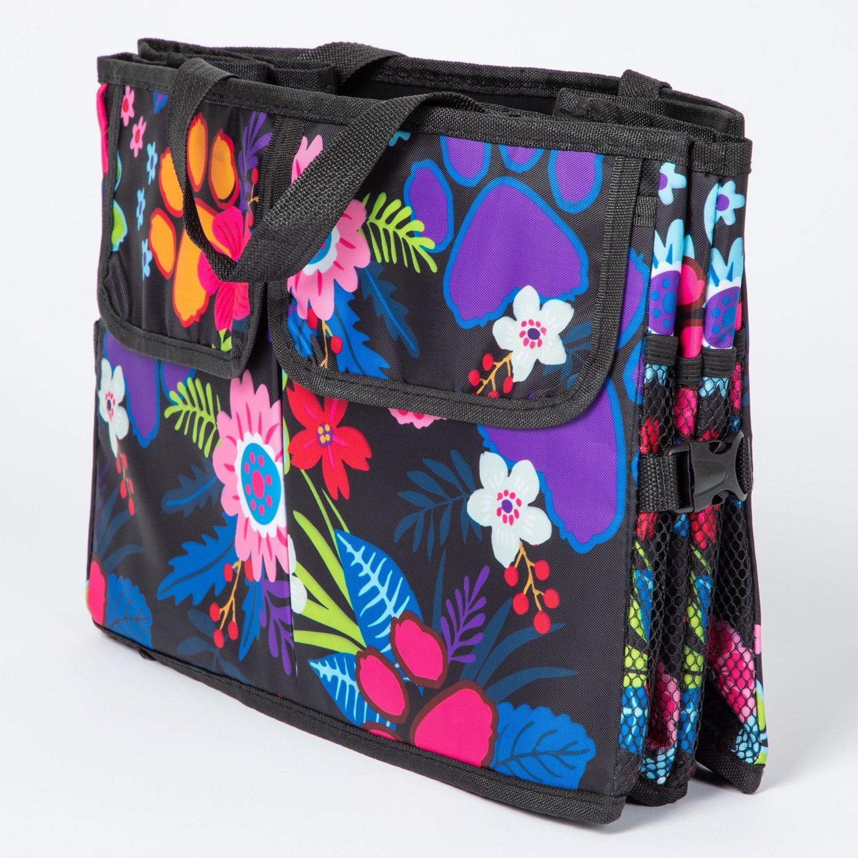 A paw print patterned car trunk organizer with pockets on the front, folded flat with a white background.